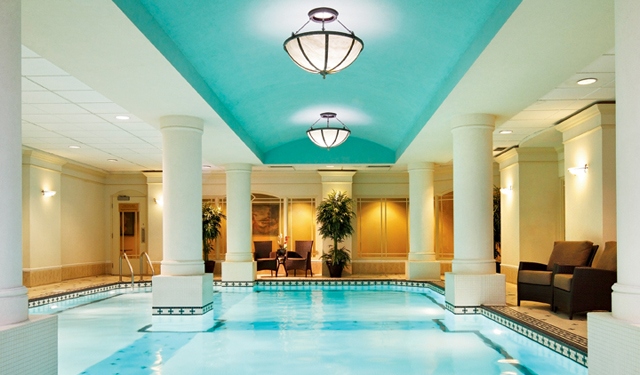 a swimming pool with columns and a chandelier