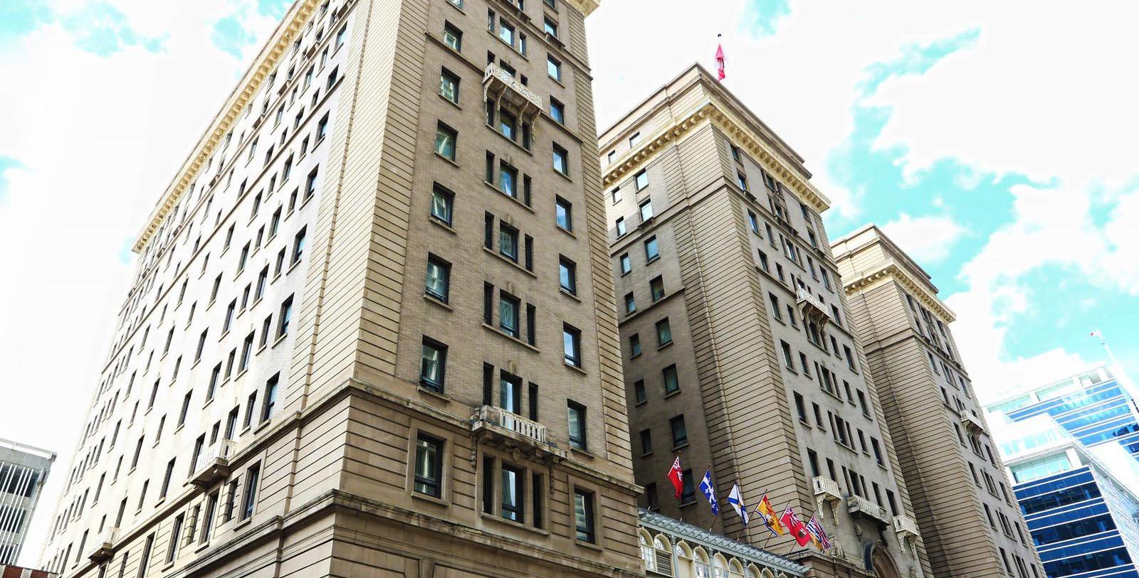 a group of tall buildings with flags