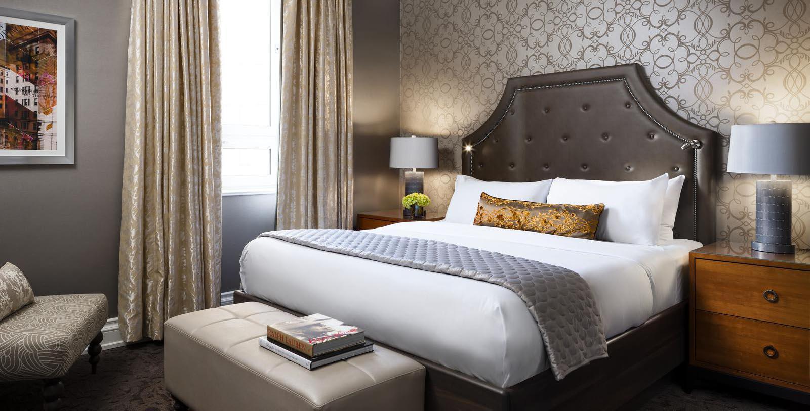 a bed with a leather headboard and a lamp