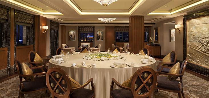 a large round table with a white tablecloth