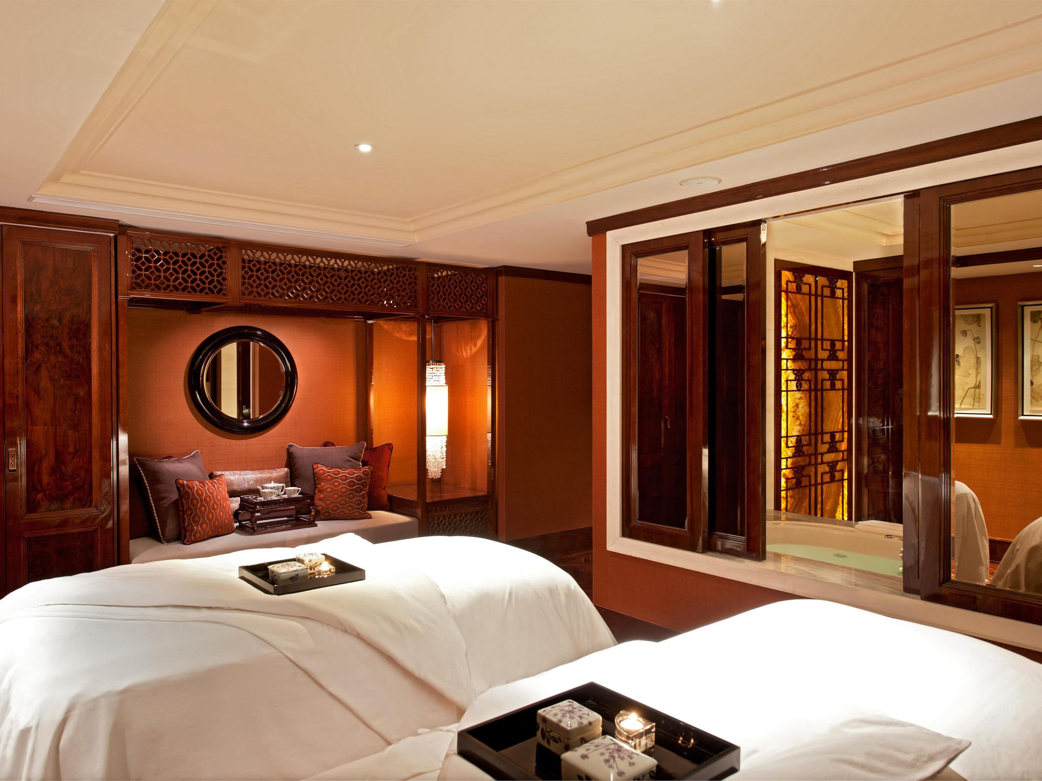 a room with two beds and a mirror