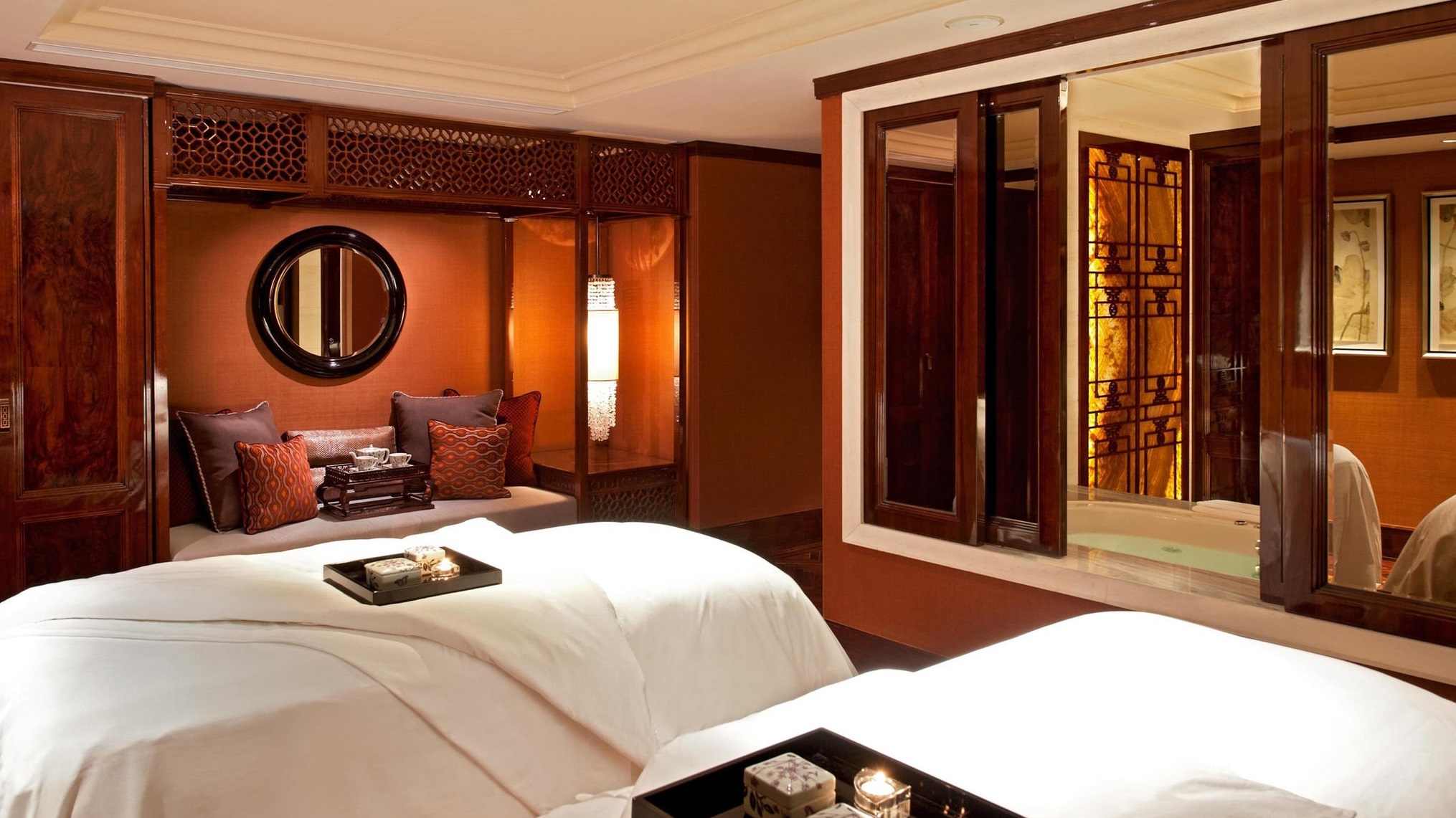 a room with two beds and a mirror