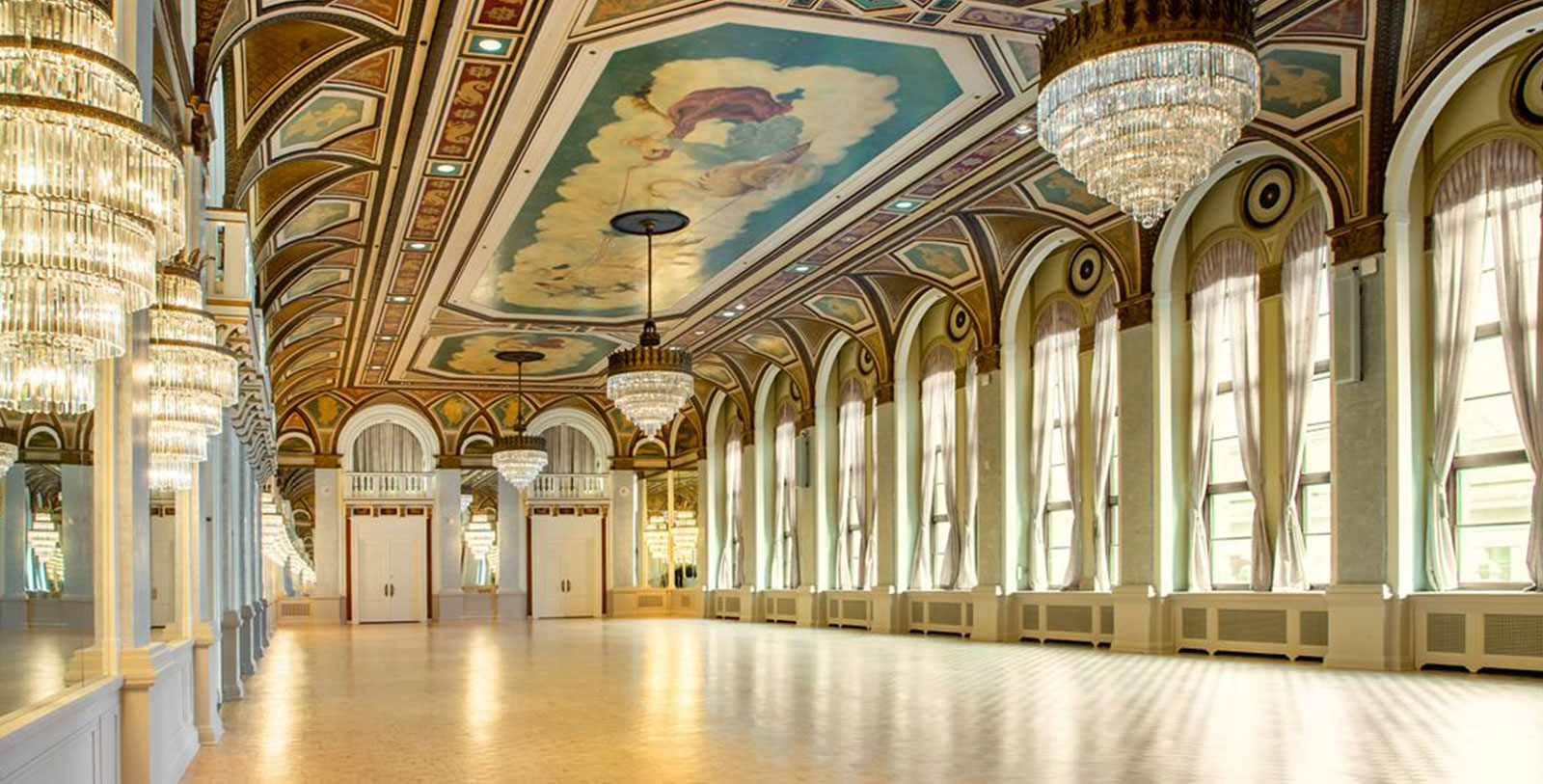 a large room with a ceiling and chandeliers