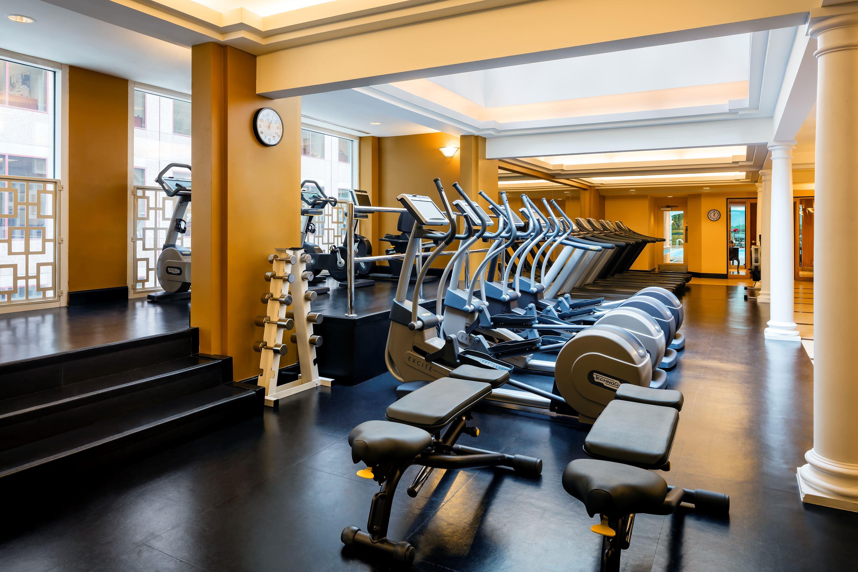 a room with exercise machines and stairs