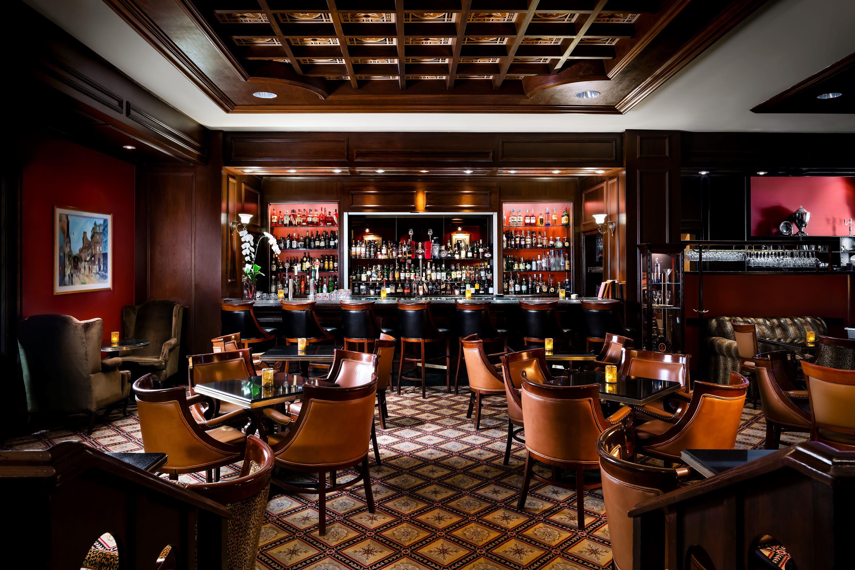 a room with a bar and chairs