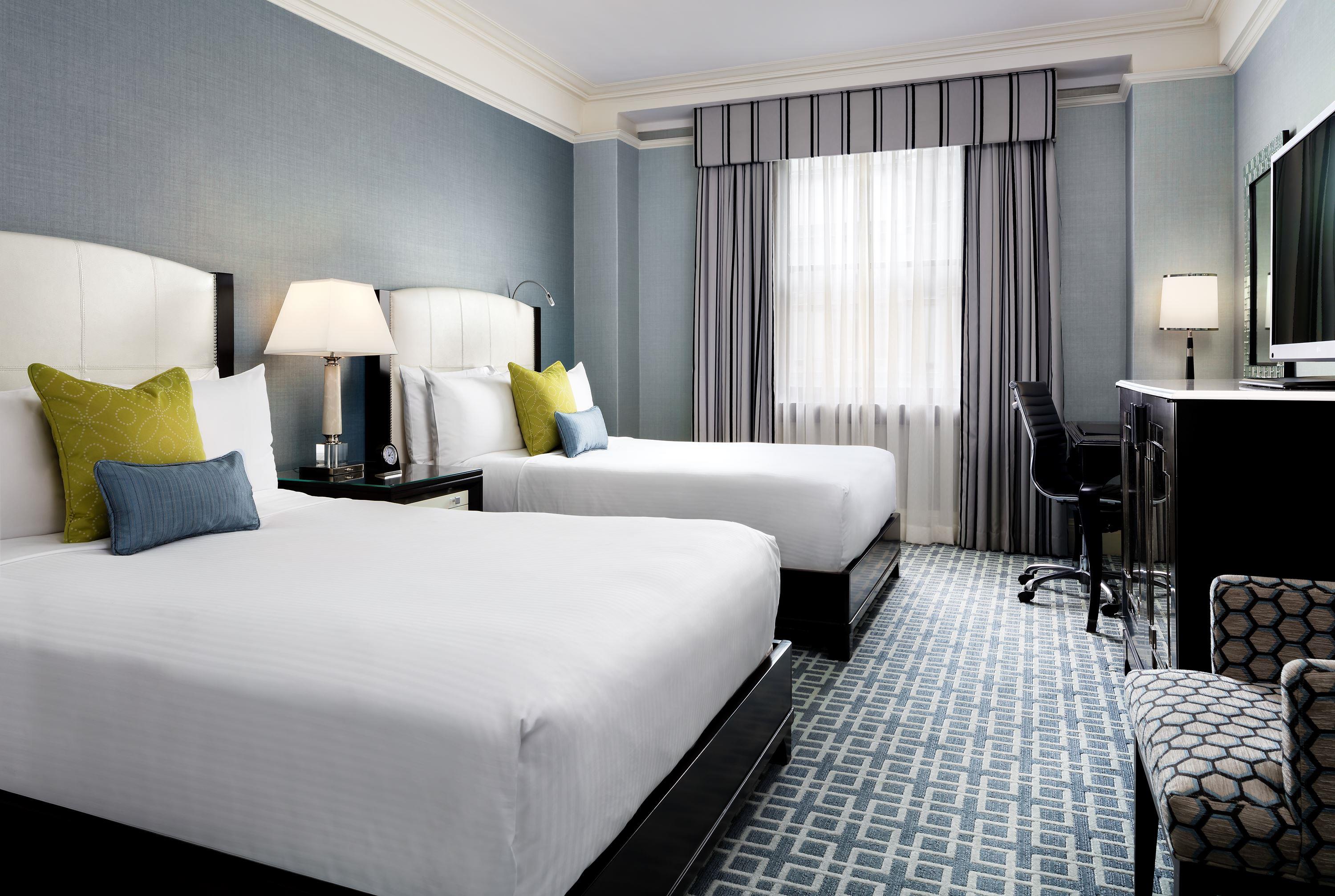 a room with two beds and a piano