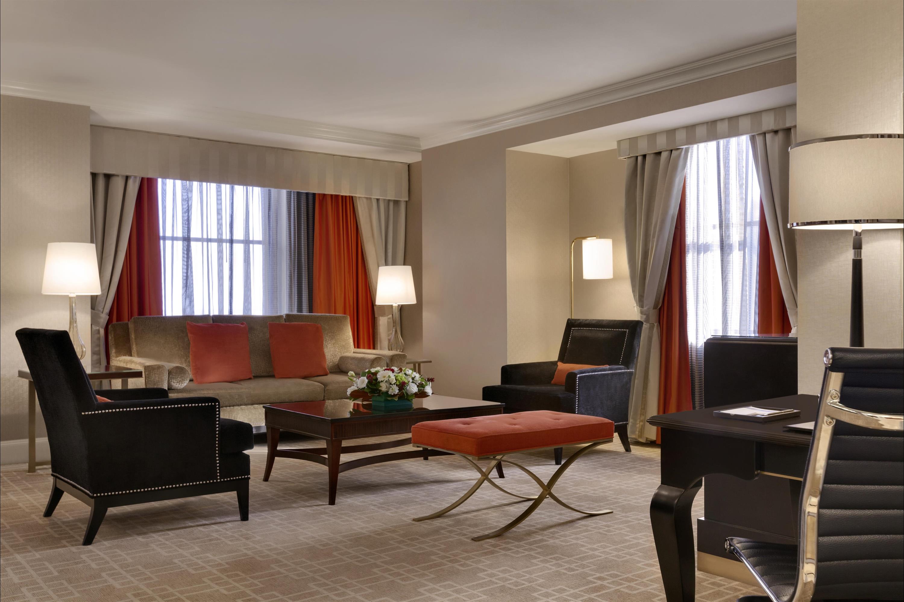 a room with a couch and chairs
