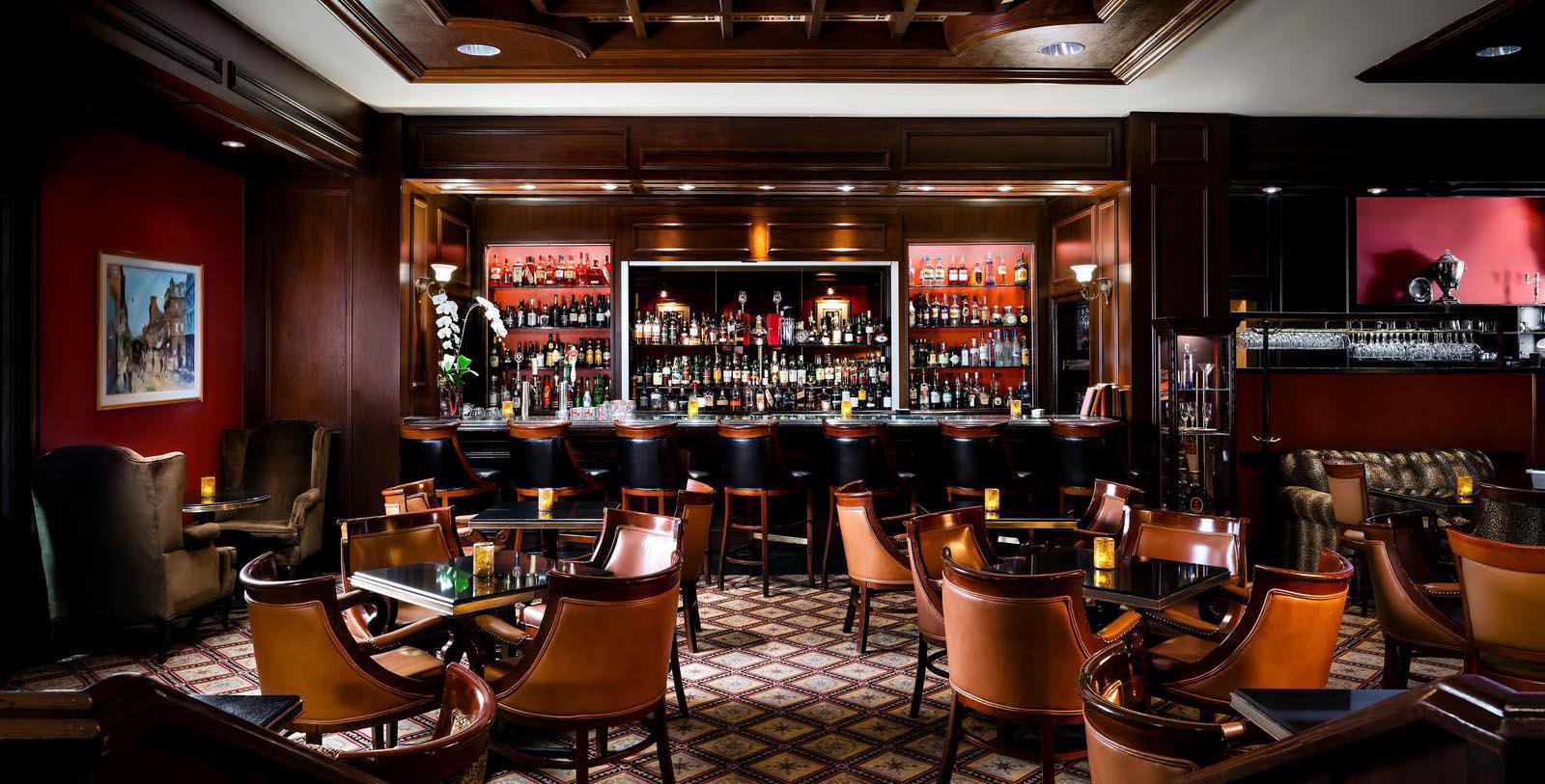 a bar with many chairs and tables