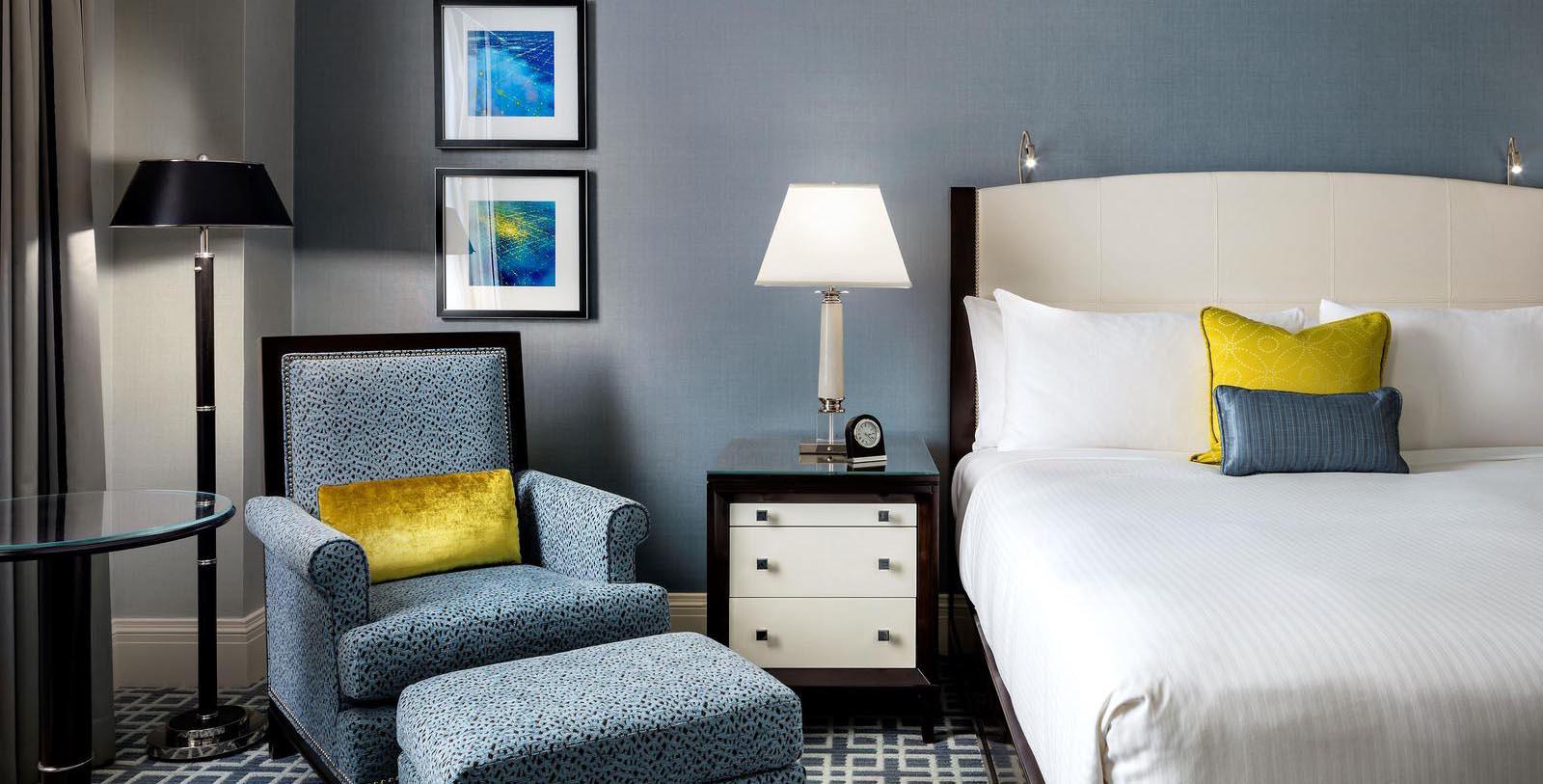 a bedroom with a bed and a chair