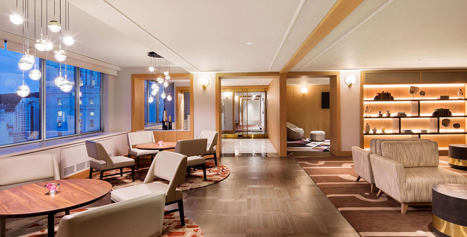 a room with white chairs and a rug