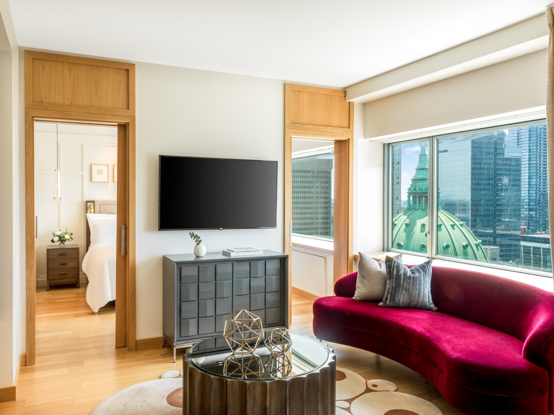 a living room with a red couch and a television