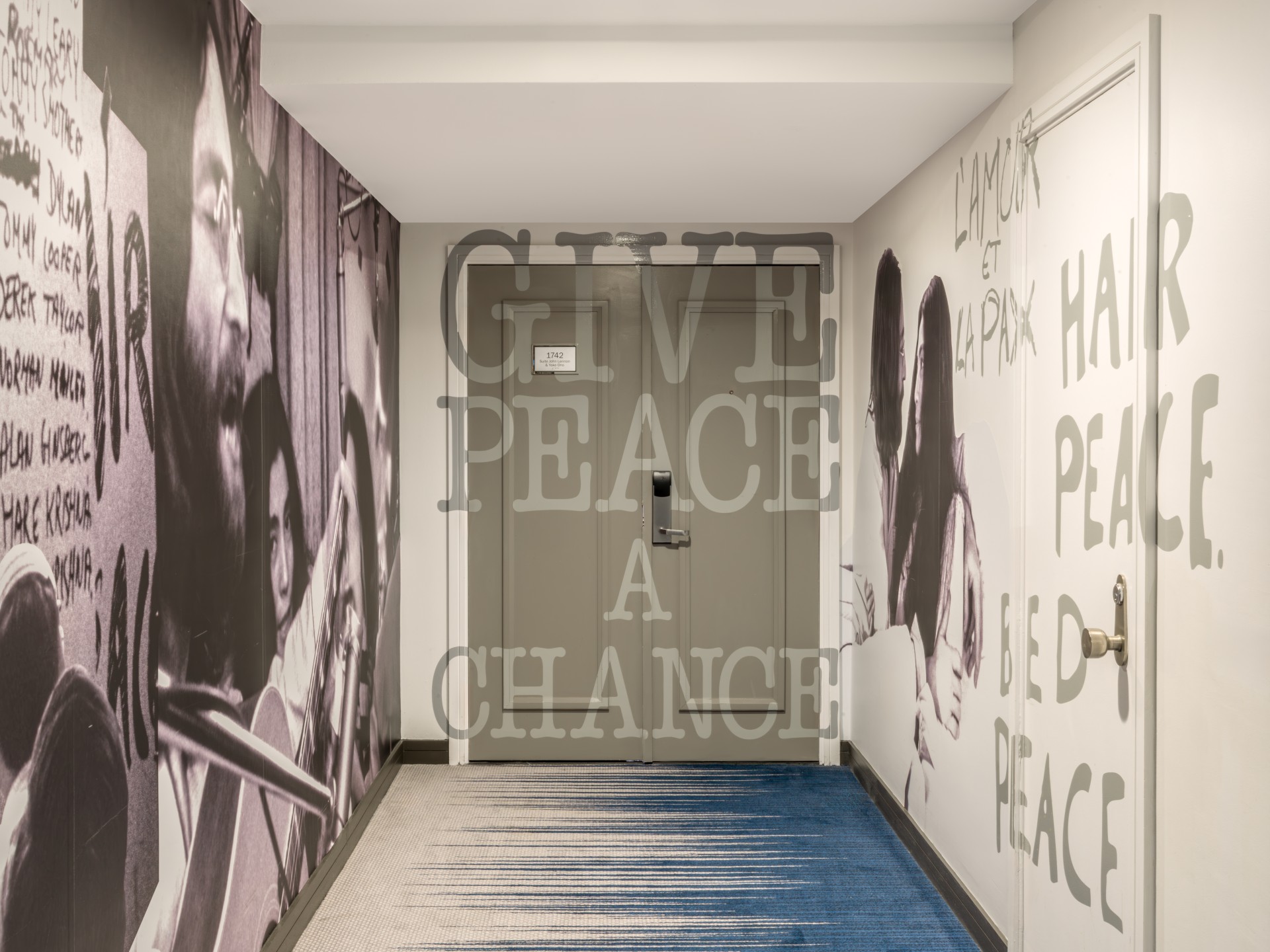 a hallway with a door and a wall with words on it
