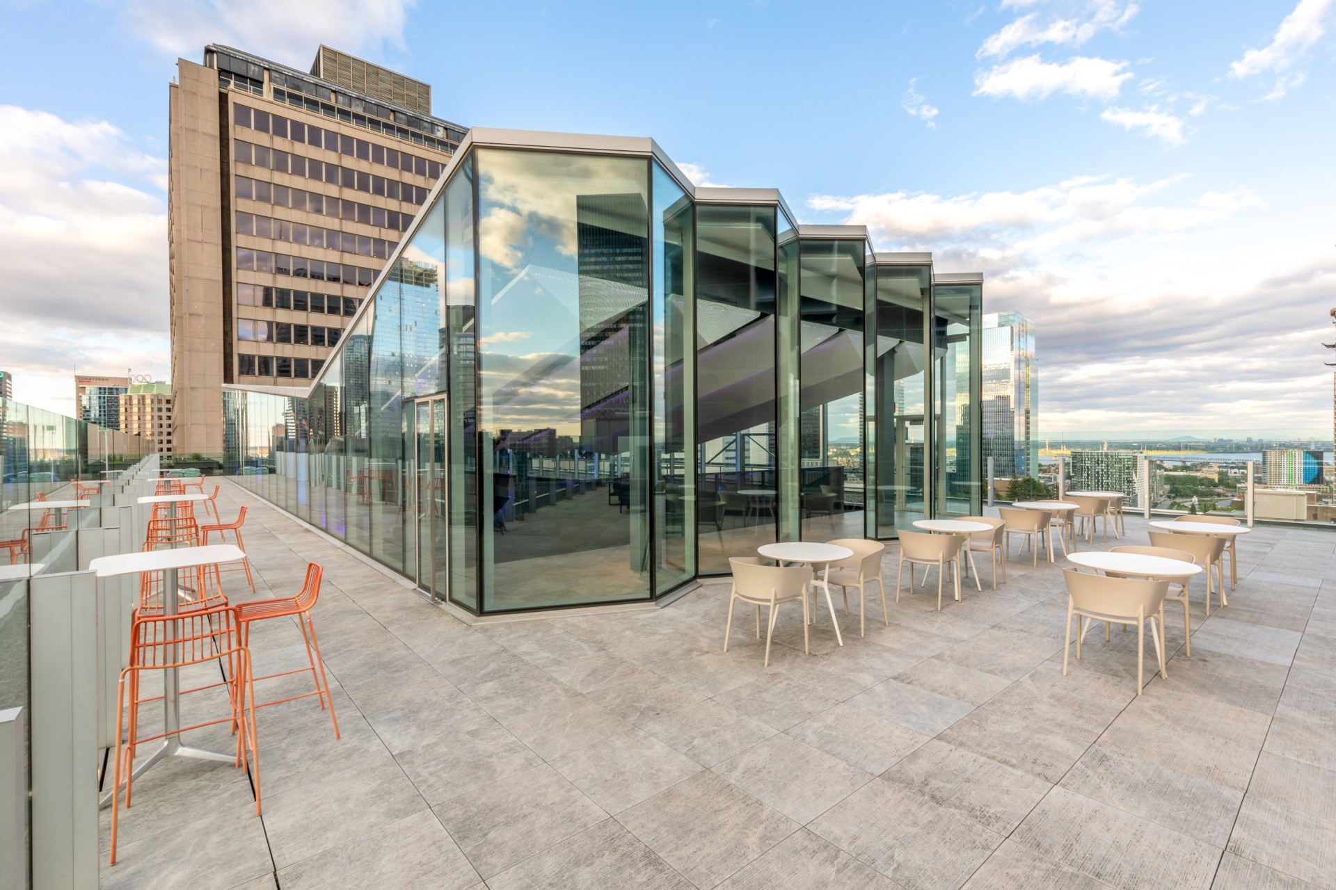 a glass building with tables and chairs
