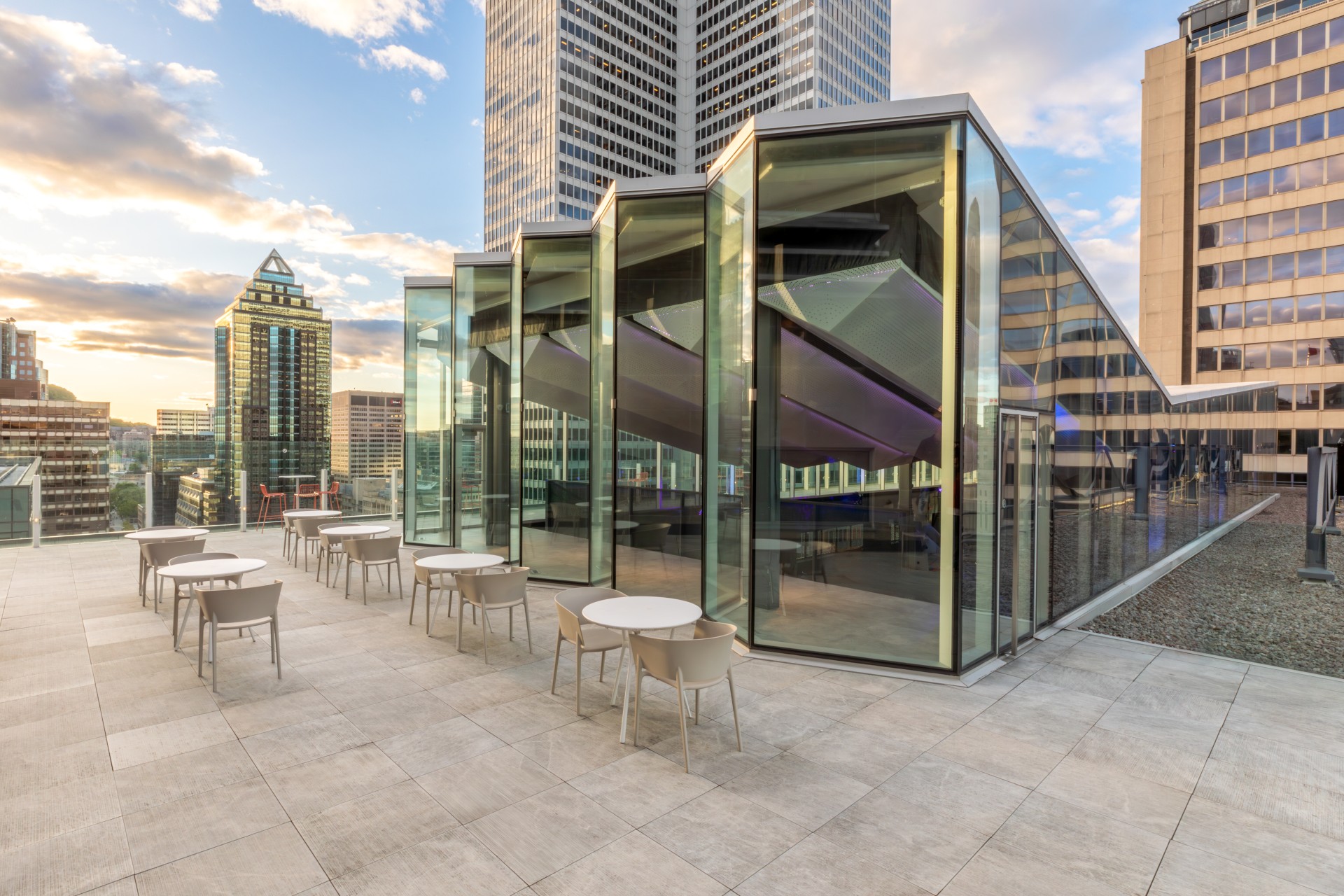 a glass building with tables and chairs