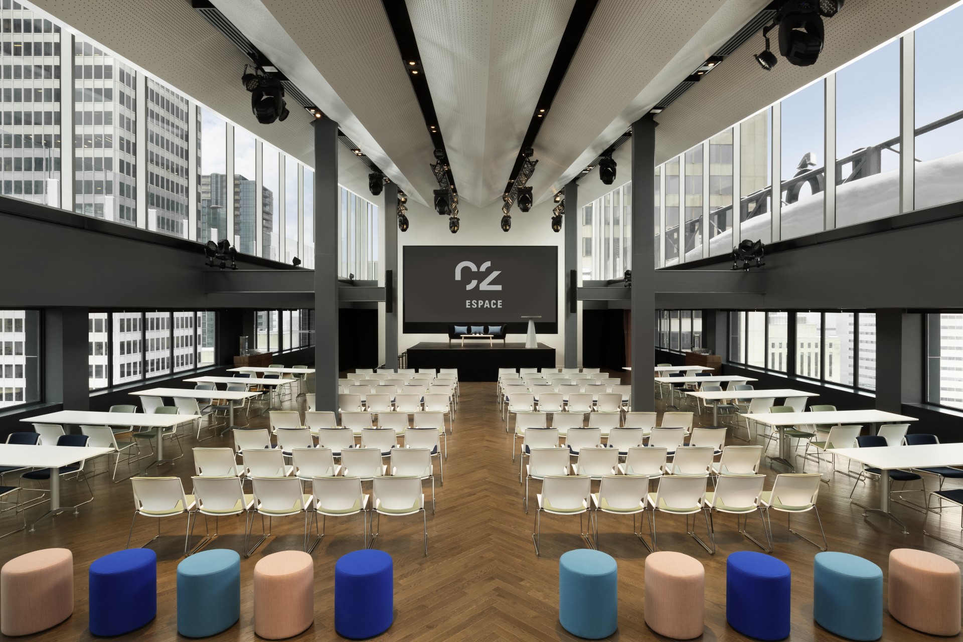a room with many chairs and a screen