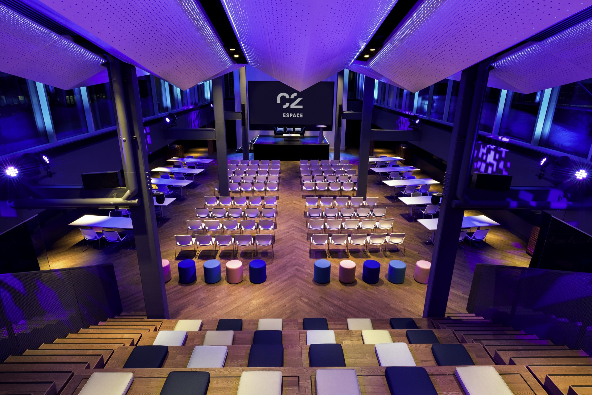 a room with rows of chairs and a screen