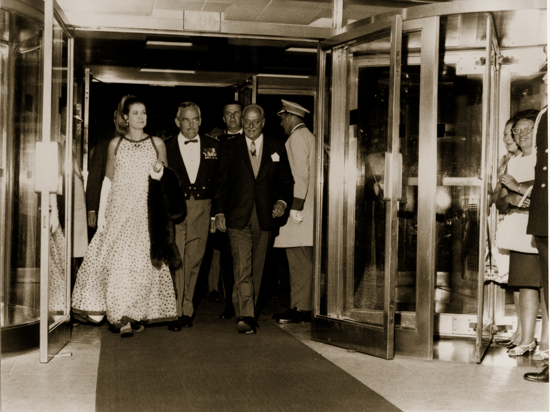 a group of people walking out of a building
