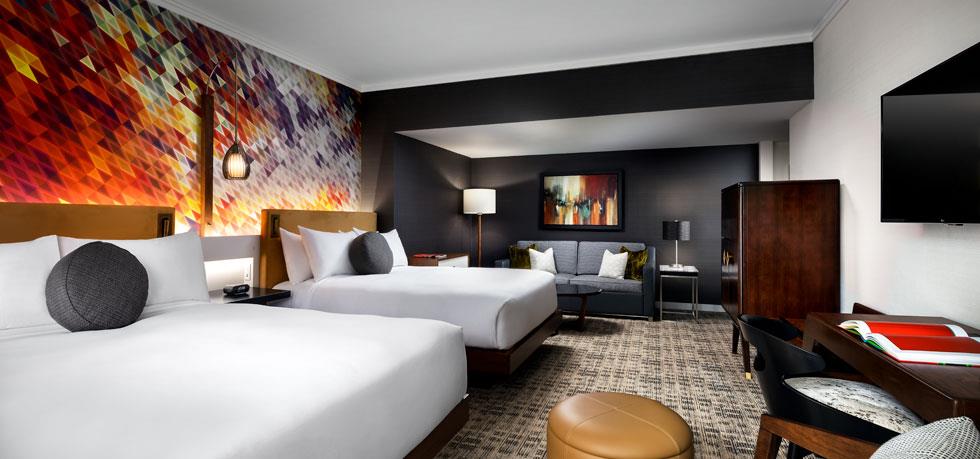 a room with two beds and a couch