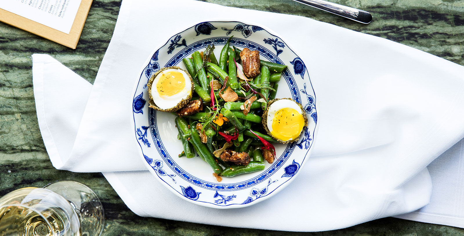 a plate of green beans and boiled egg