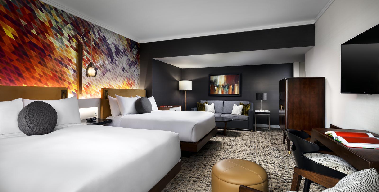 a room with two beds and a couch