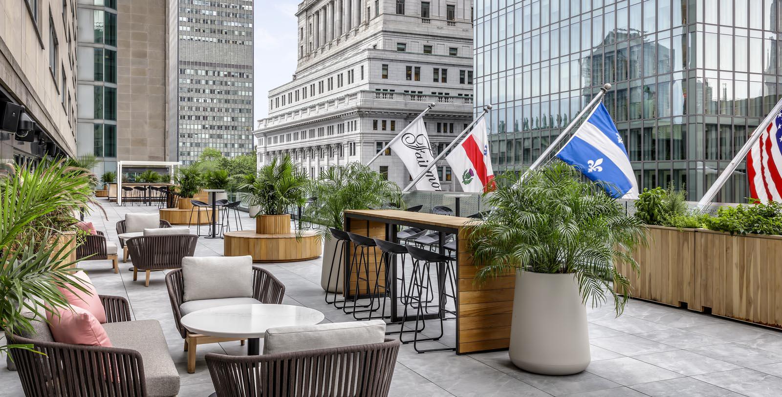 a patio with chairs and tables and flags