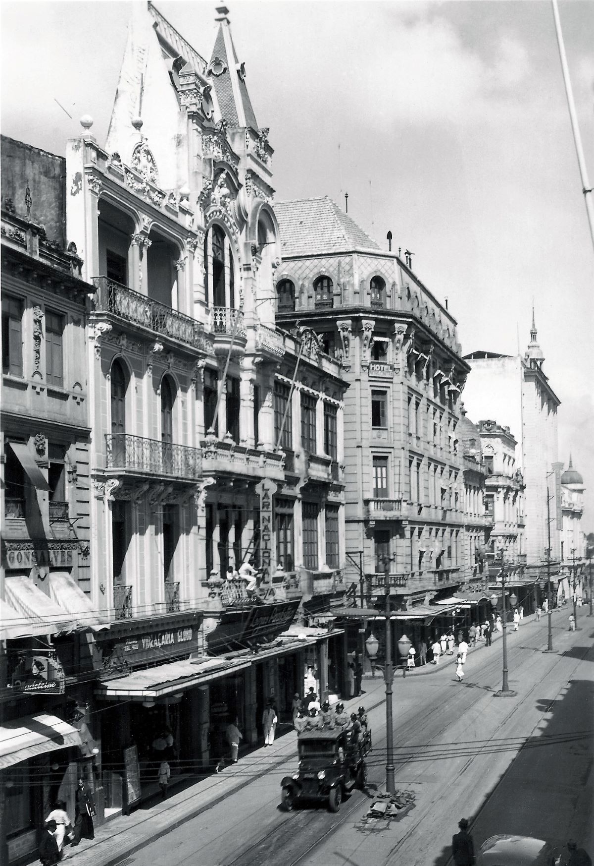 a street with buildings and people walking on it