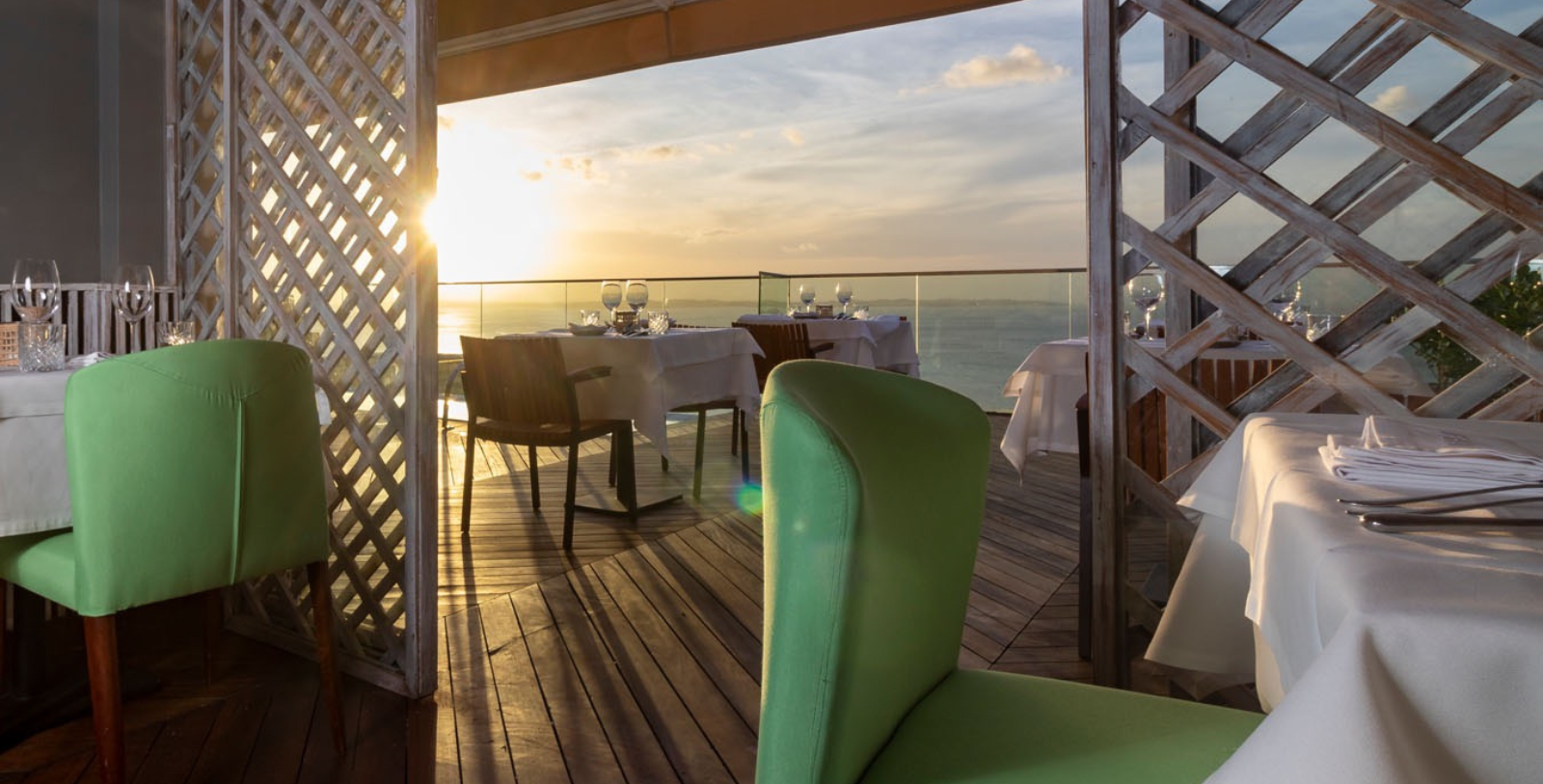 a table set up on a deck with a view of the ocean