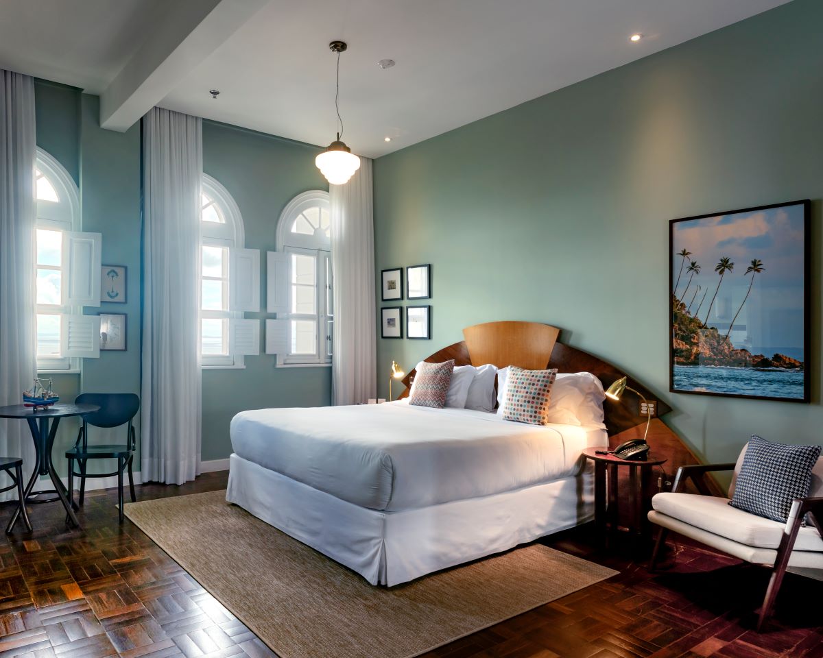 a bedroom with a bed and chairs