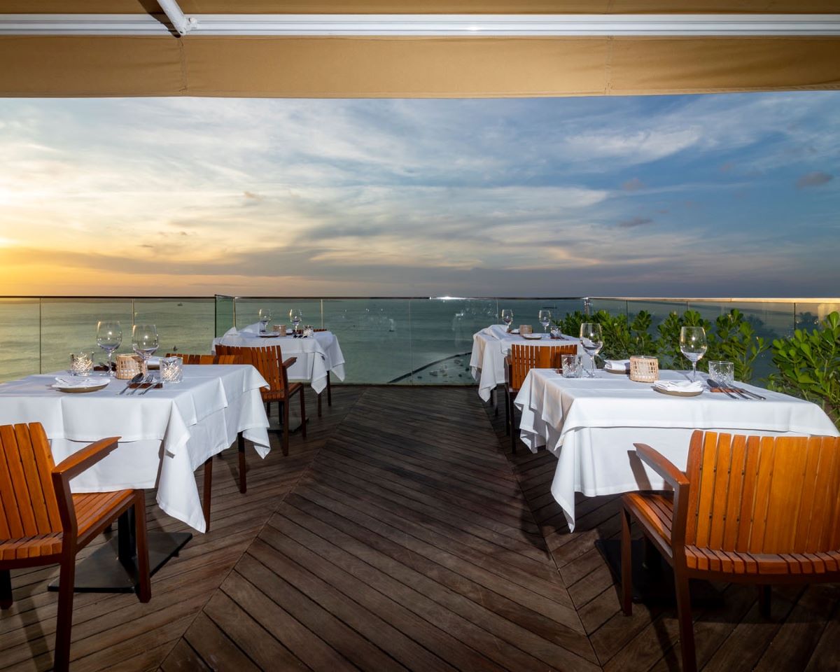 a table set up on a deck overlooking a body of water