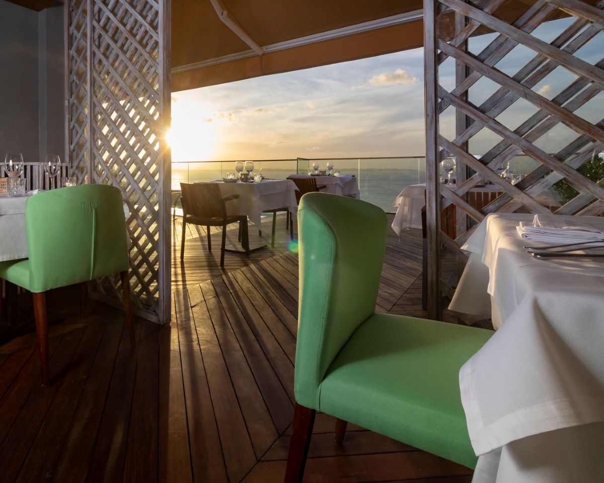a table set up with chairs and tables on a deck