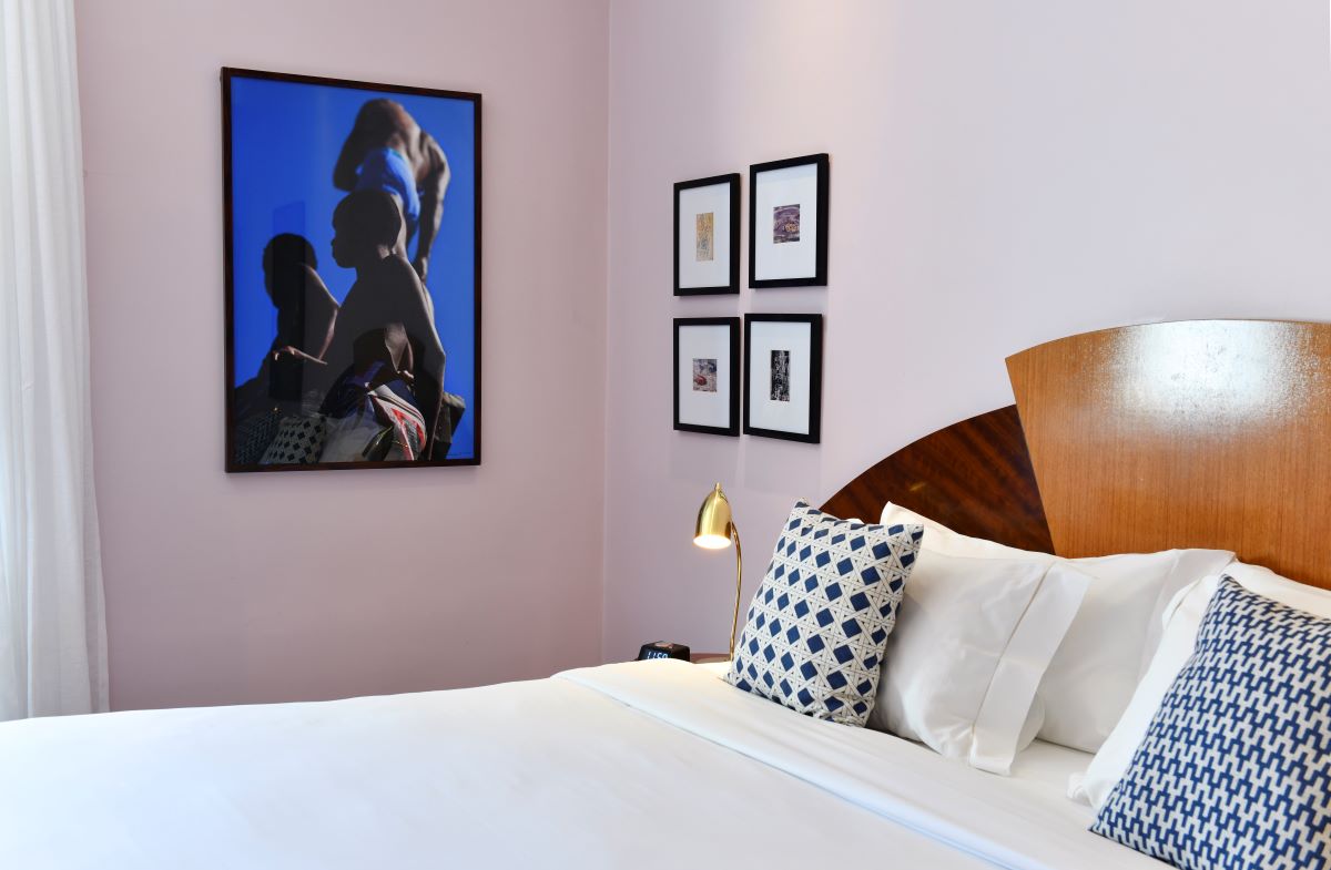 a bed with a picture on the wall