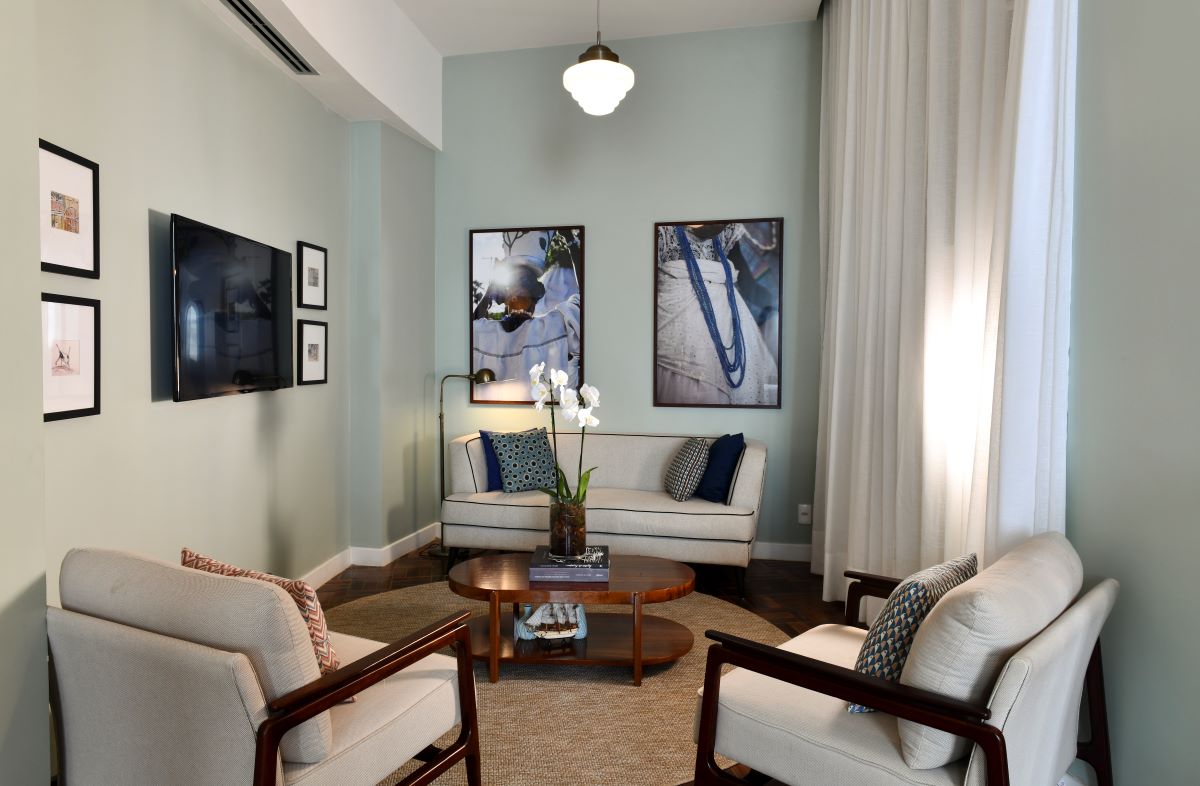 a living room with white furniture and a coffee table
