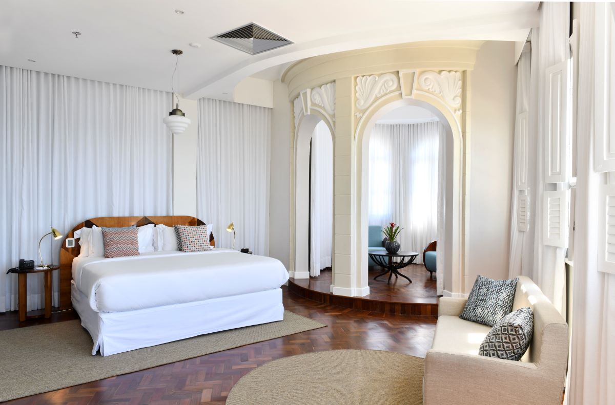 a room with a bed and couches