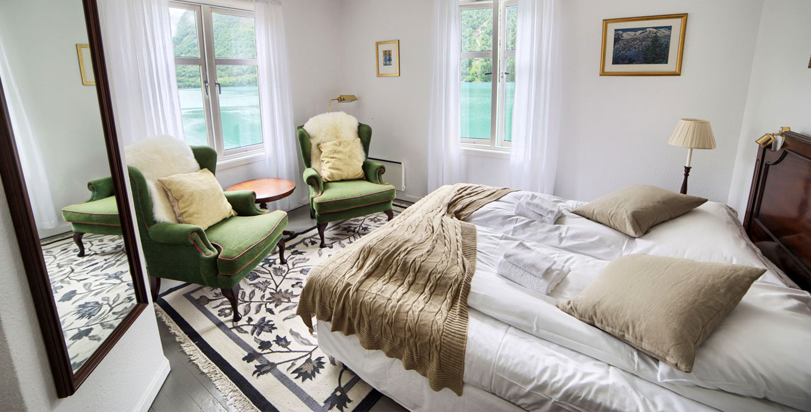 a bedroom with a bed and chairs
