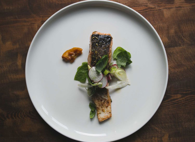 a plate of food on a wood table