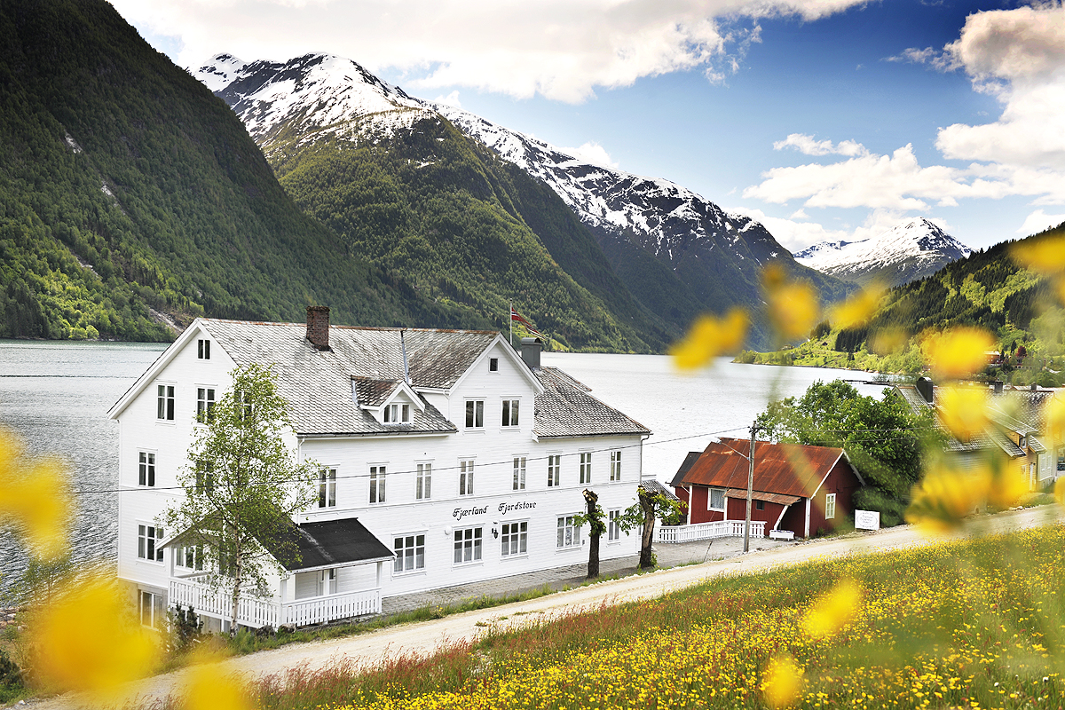 a white building next to a lake