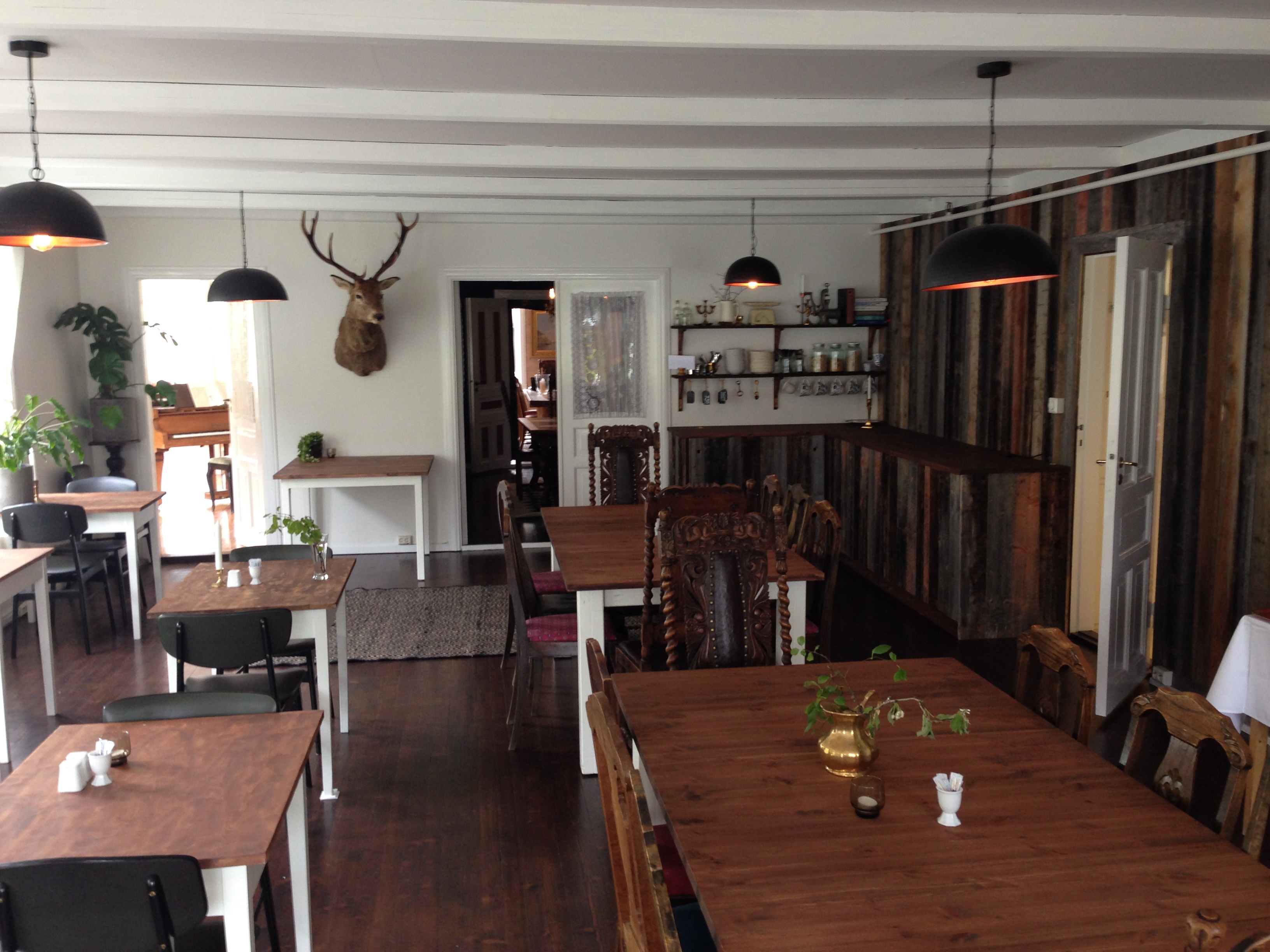 a room with wooden tables and chairs