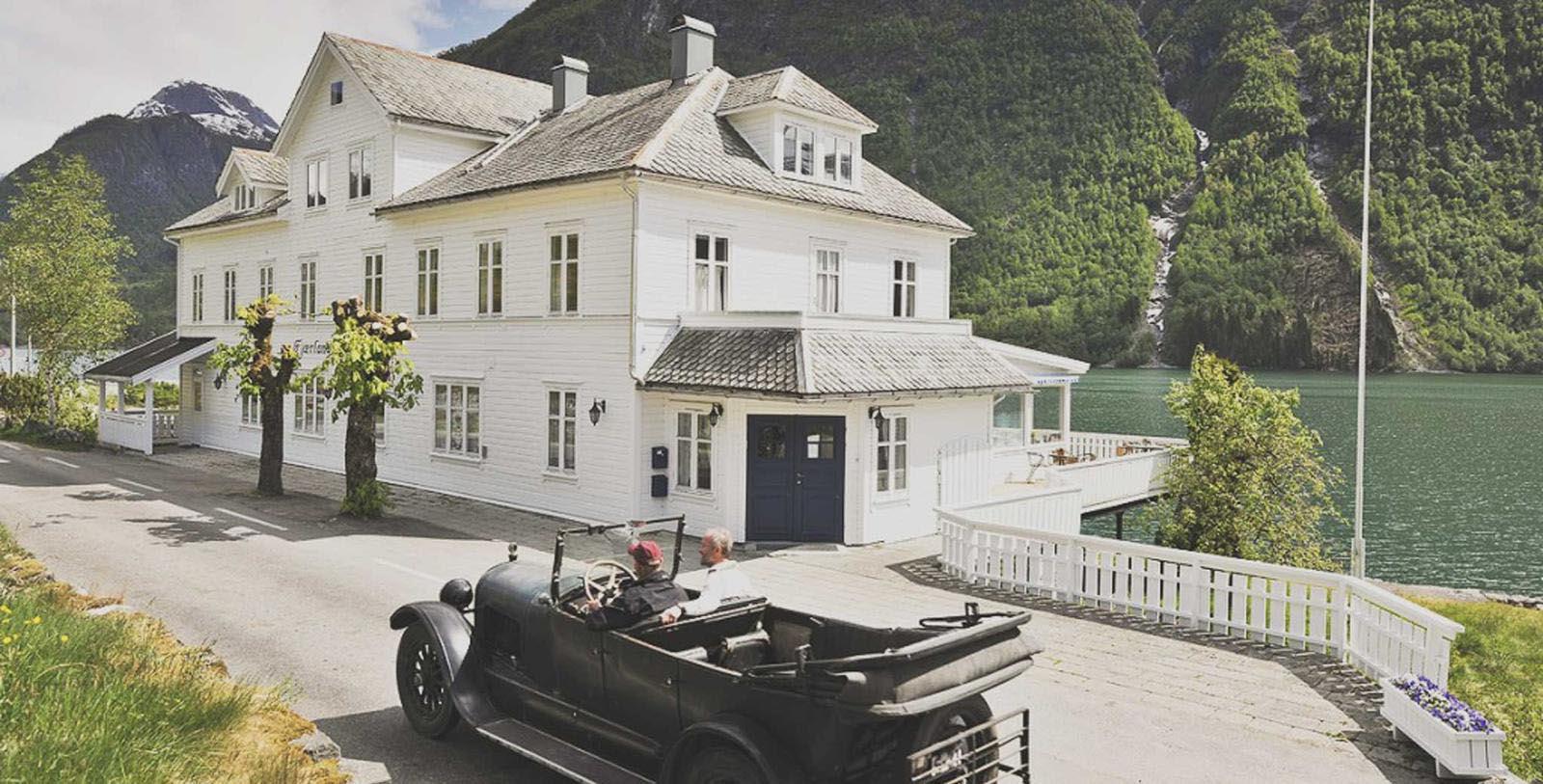 a car on the road by a house