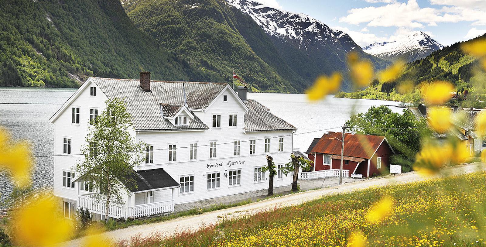 a white building next to a lake