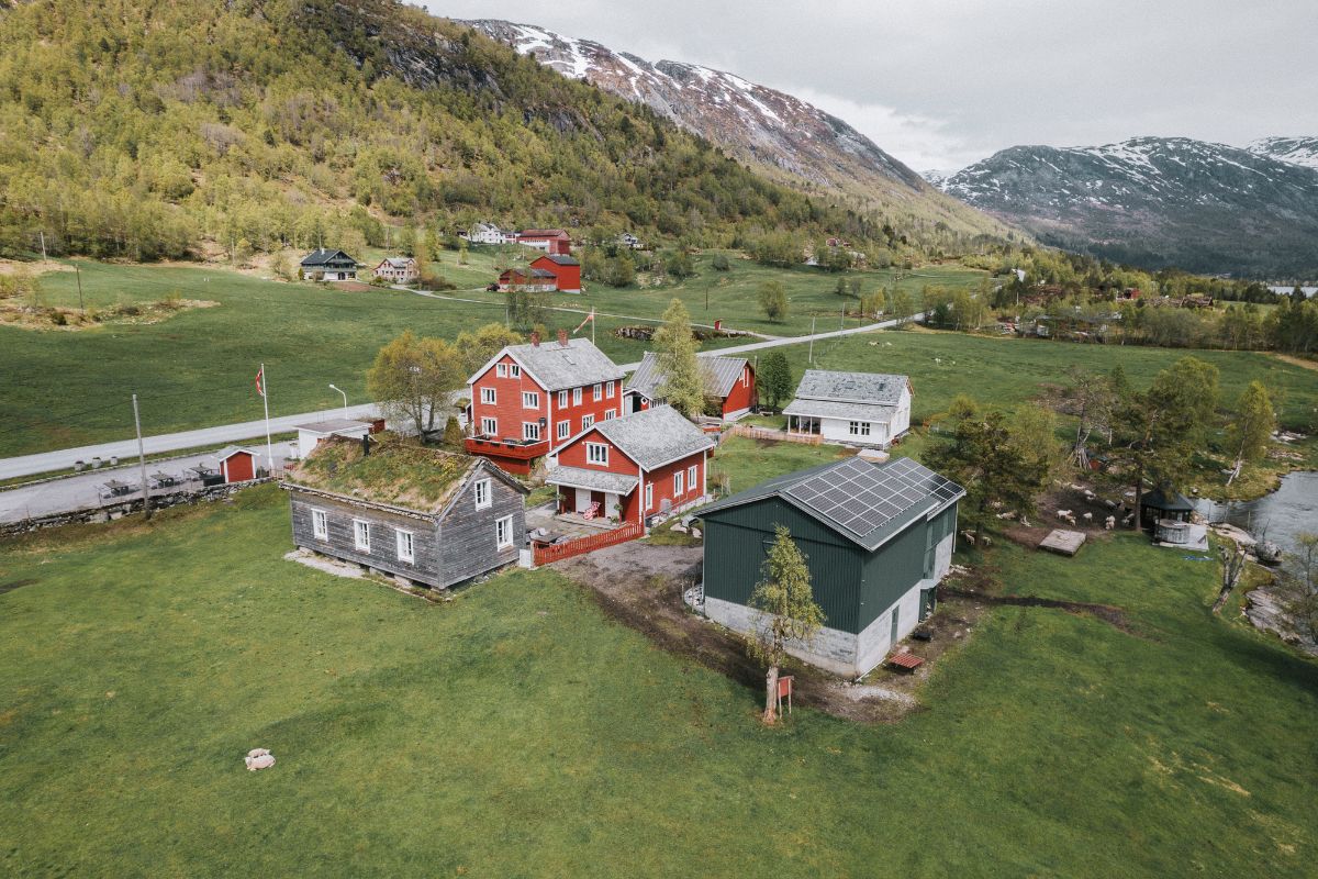 a group of houses in a green field