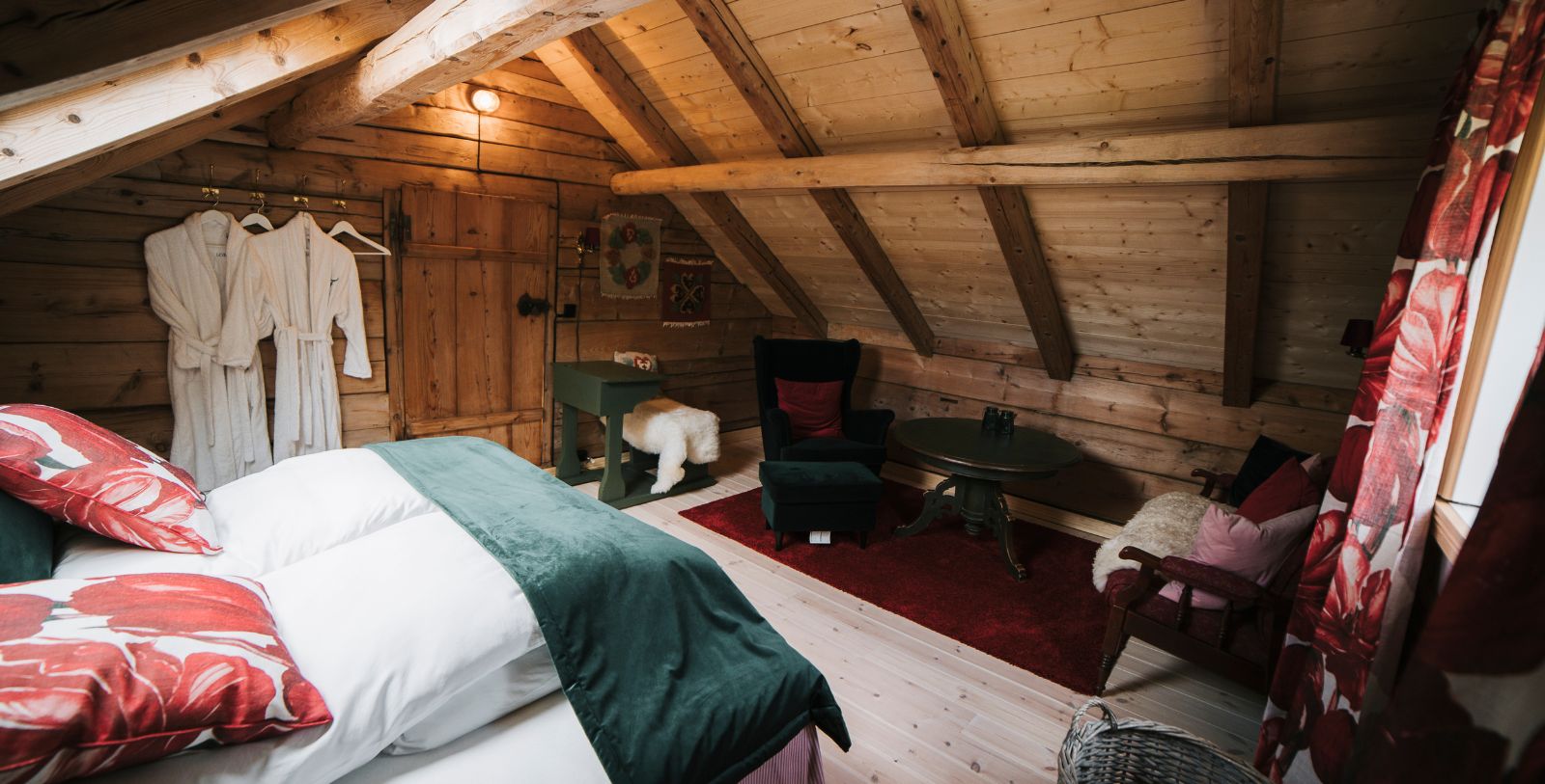 a room with a bed and a table and chairs