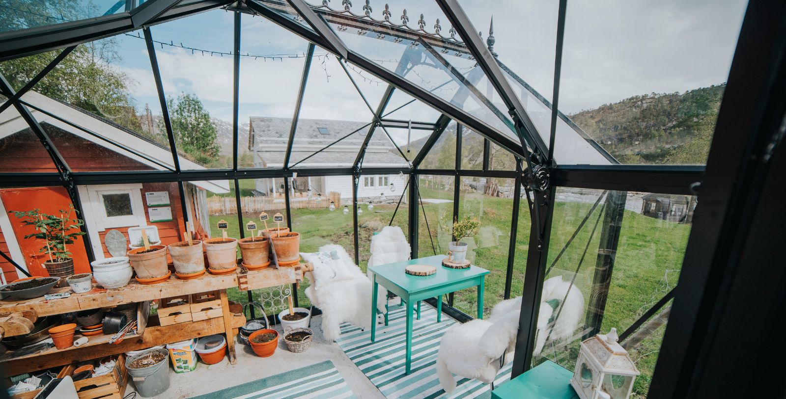 a glass room with a table and chairs