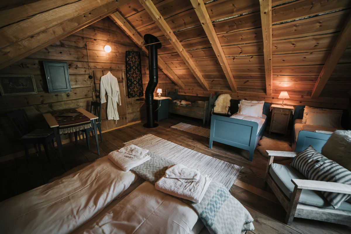 a room with a wood ceiling and a wood stove