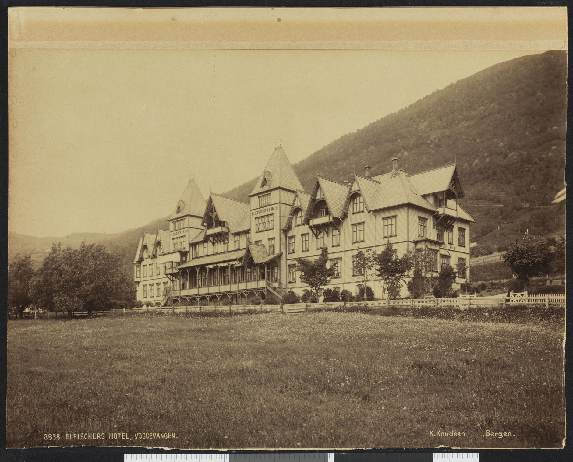 a large building with a hill in the background