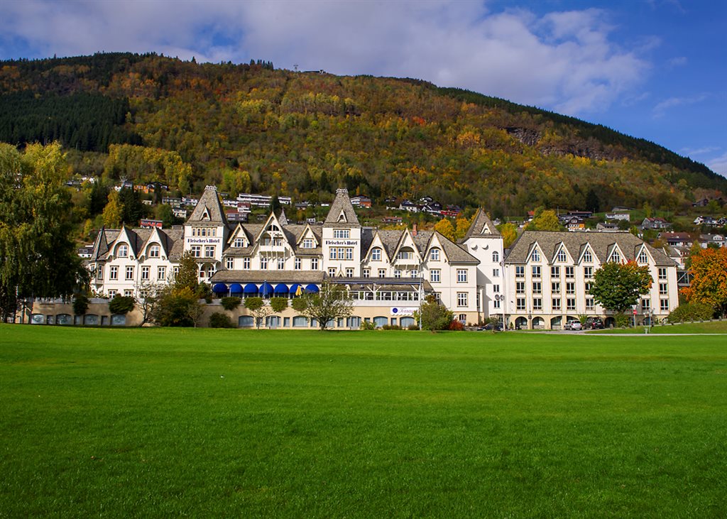 a large building with a grassy field in front of it