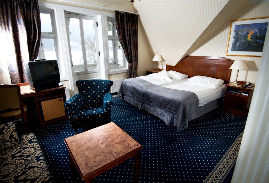a room with a bed and a television