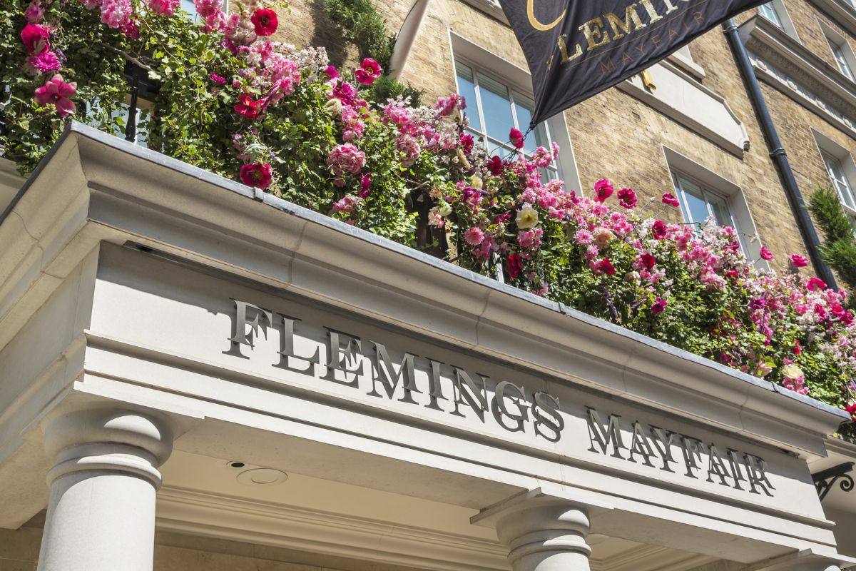 a building with flowers on the balcony