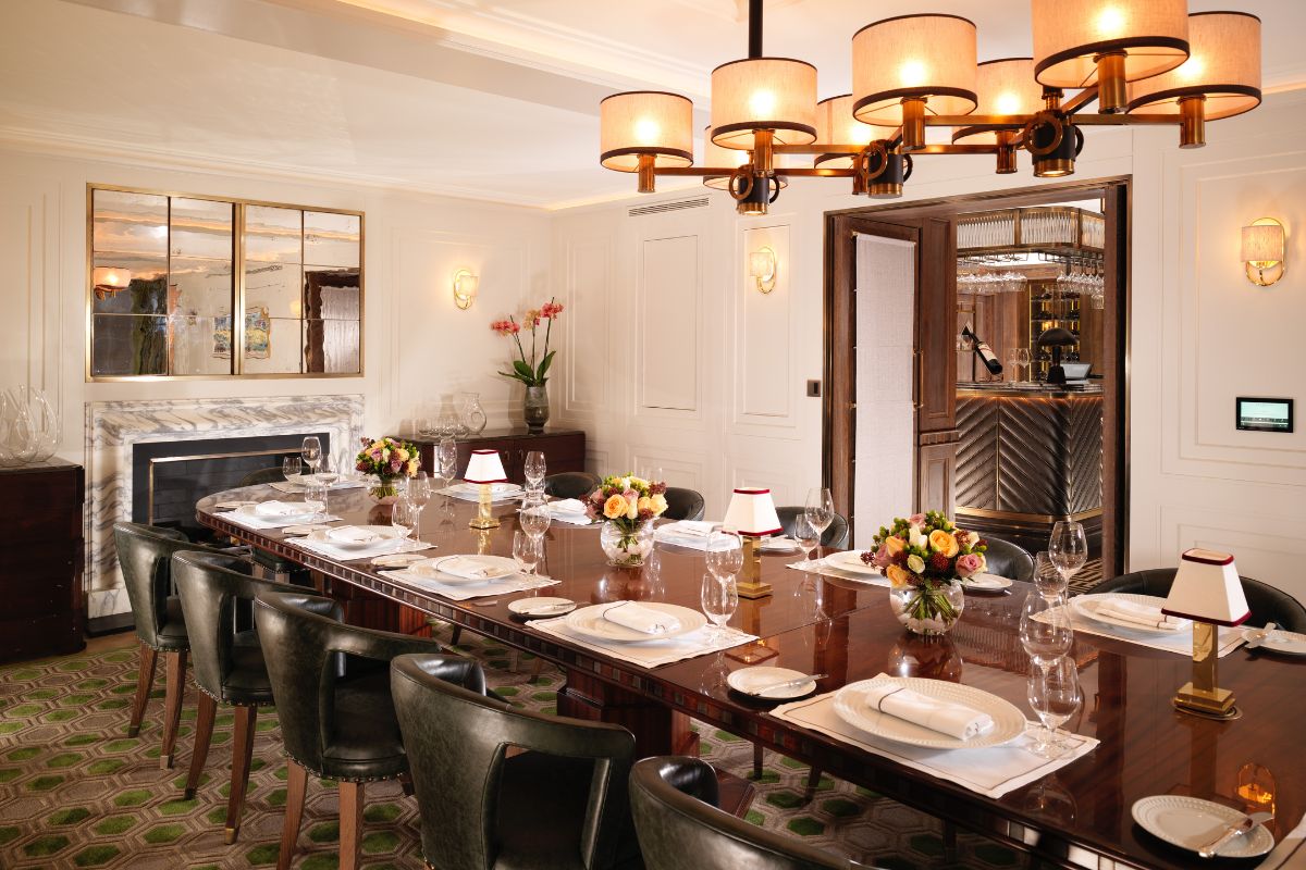 a large dining room with a large table set with plates and glasses