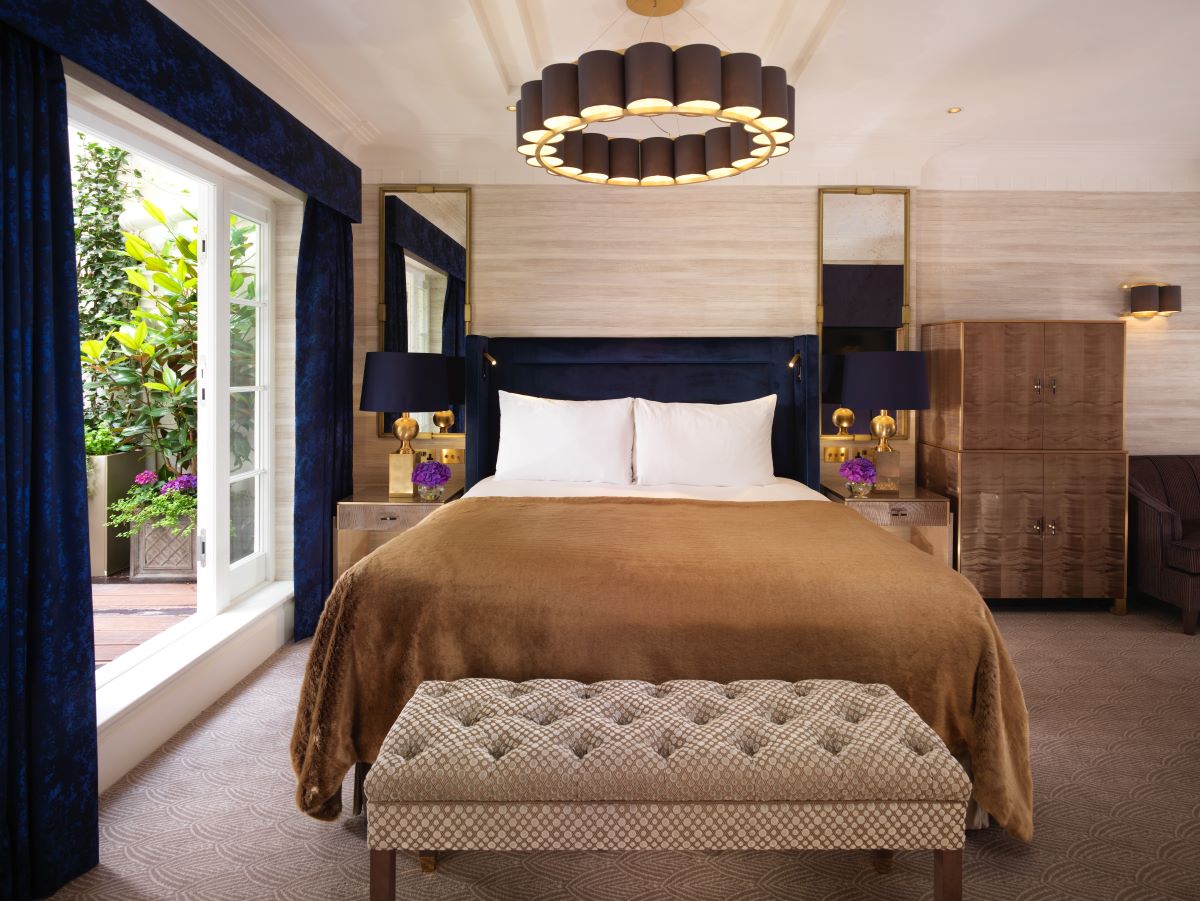 a bed with a chandelier and a window