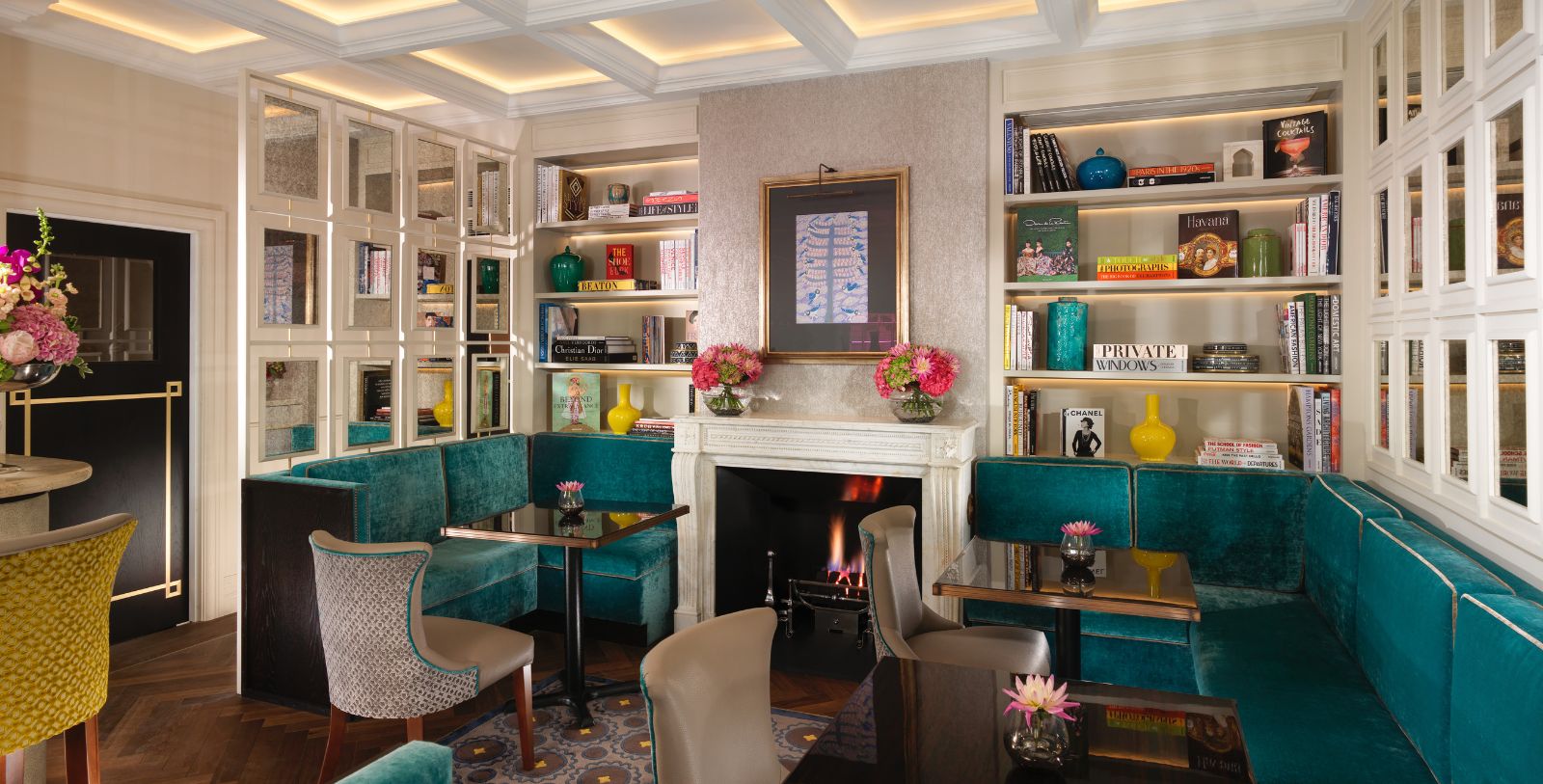 a room with a fireplace and tables